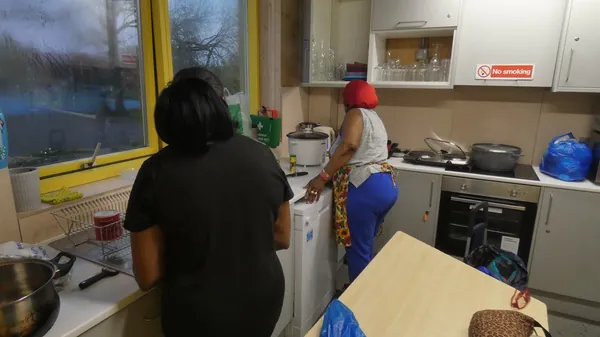 Volunteers cooking in the Centre kitchen