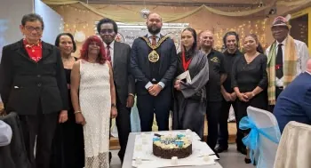 The Mayor of Haringey in his chain of office with Centre members and committee around the silver jubilee cake